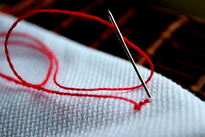 a close up of a piece of cloth with a needle
